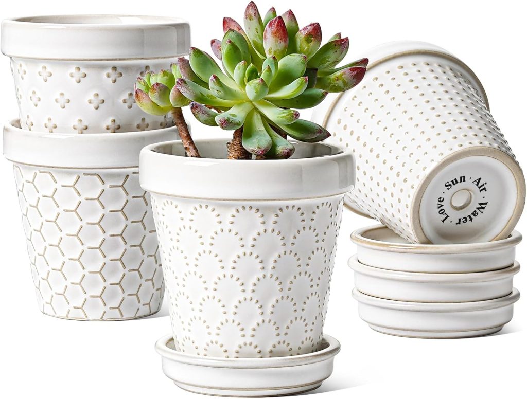Five white ceramic plant pots with embossed patterns; one contains a succulent, and three pots are stacked with matching saucers, perfect for creating a charming succulent wreath display.