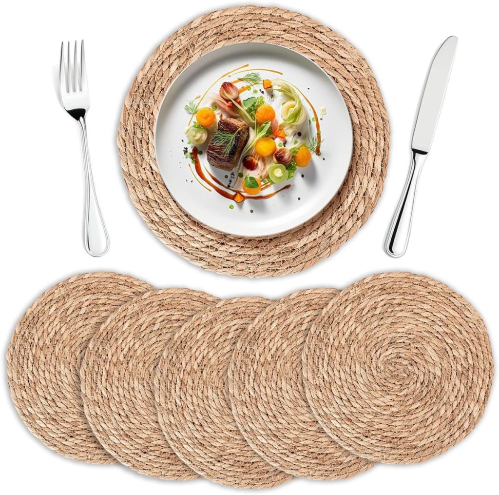 A set of five round woven placemats is shown, with one in use under a plate of food, knife, and fork beside it&mdash;perfect for elevating your everyday tablescapes.