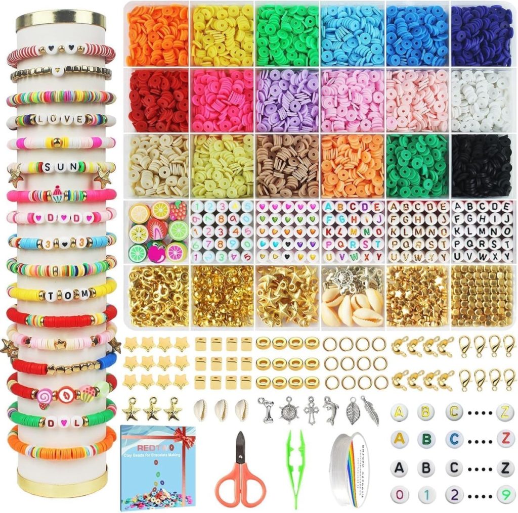 Assorted jewelry-making kit perfect for a staycation, featuring colorful beads, letter beads, charms, tools, scissors, elastic string, clasps, and finished sample bracelets displayed on stackable holders.