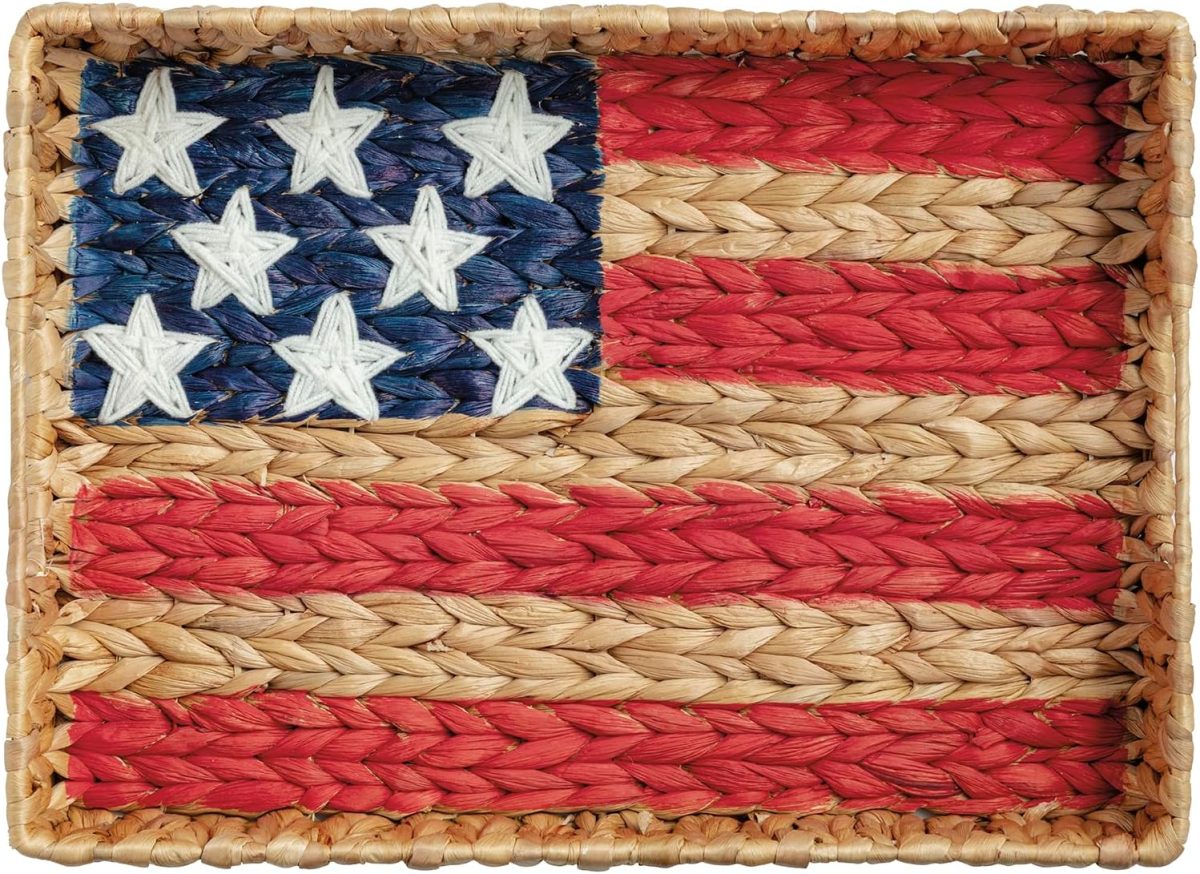 A woven basket features a design resembling the American flag, with red, white, and blue sections and white stars on a blue background—perfect for Memorial Day celebrations.