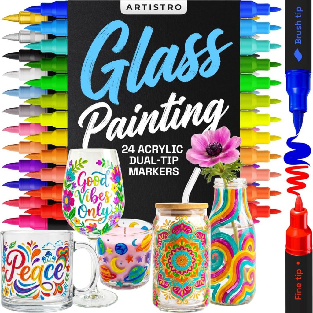 A set of 24 dual-tip acrylic markers in various colors arranged around decorated glassware, labeled “Glass Painting” by Artistro. Perfect for adding creativity to your staycation, with brush and fine marker tips shown enlarged on the right.