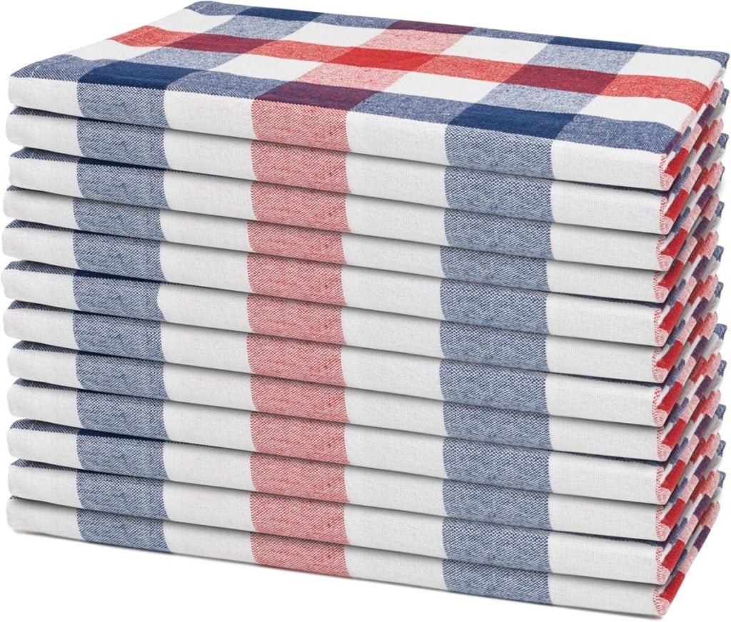 A stack of sixteen folded cloth napkins with a red, white, and blue checkered pattern—perfect for your Memorial Day gathering.