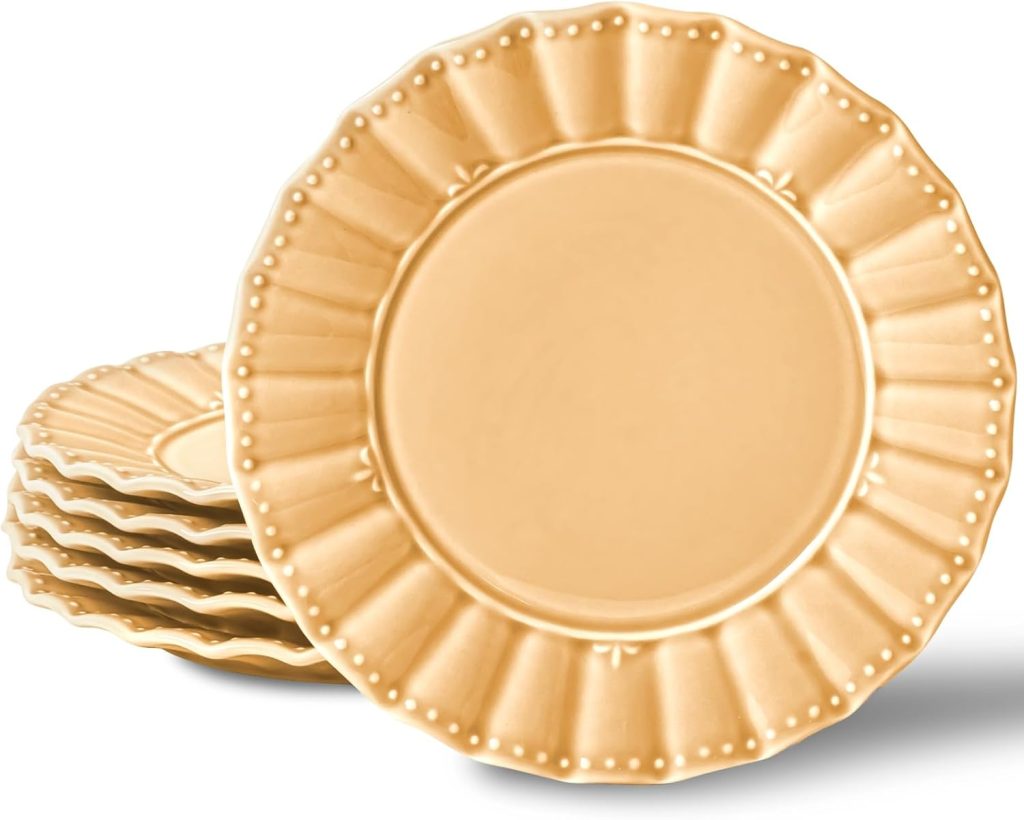Five stacked gold plates with scalloped, beaded edges and a raised decorative pattern, shown on a white background.