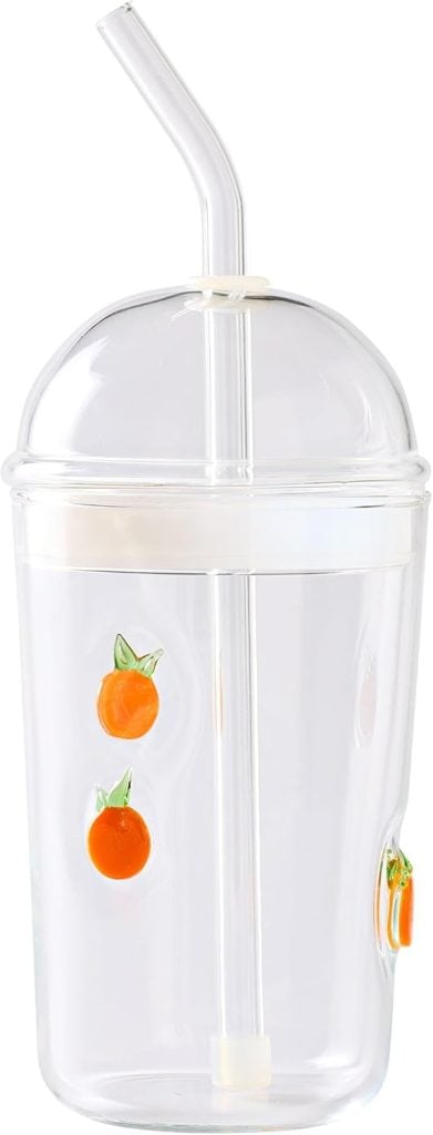 Clear plastic cup with a dome lid and straw, decorated with playful orange fruit illustrations reminiscent of a refreshing creamsicle.