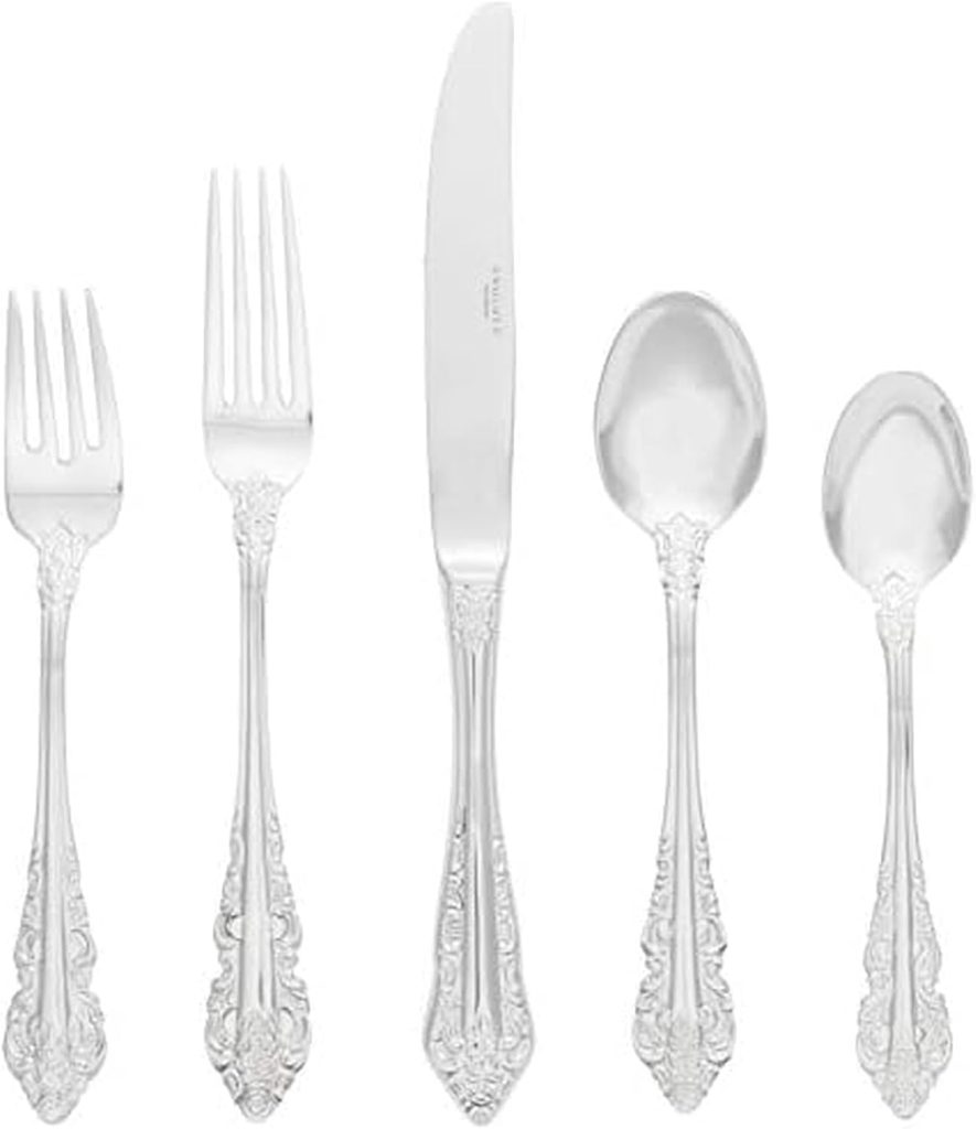 Five pieces of ornate silverware—two forks, a knife, a soup spoon, and a teaspoon with matching decorative handles—are arranged in a row on a white background, ready to impress at your next elegant dinner party.