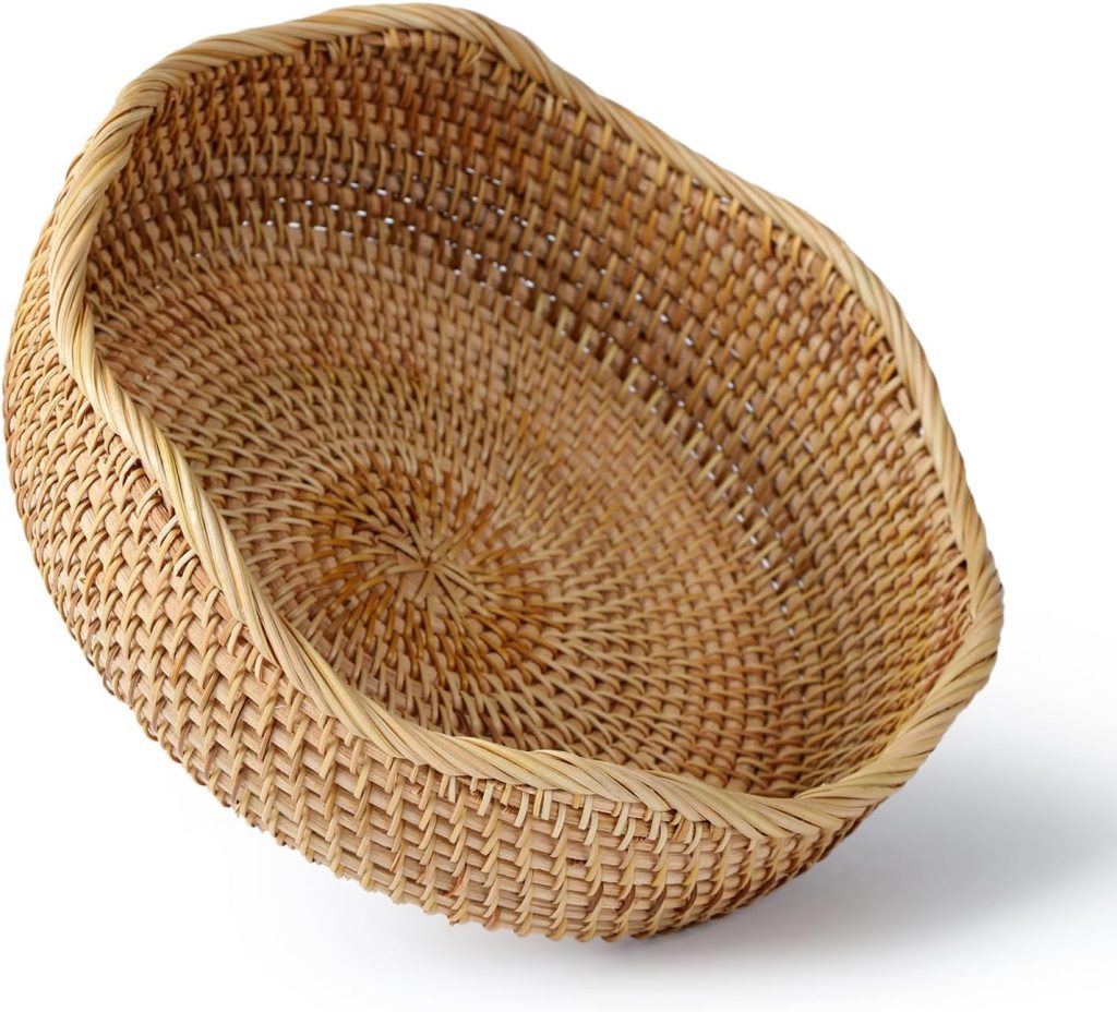 A round, shallow wicker basket with a woven pattern, shown at an angle on a white background.