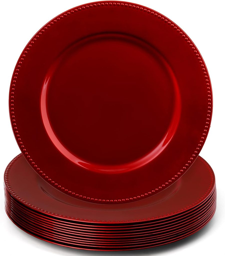A stack of glossy red plates with beaded rims, crafted from air dry clay, with one plate standing upright in front of the others.