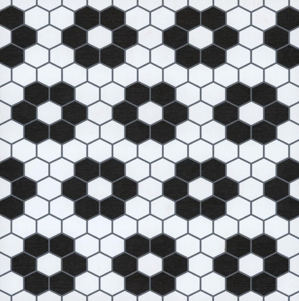 Hexagonal tile pattern with alternating black and white tiles, forming a repeating geometric design reminiscent of a classic Nancy Meyers interior.