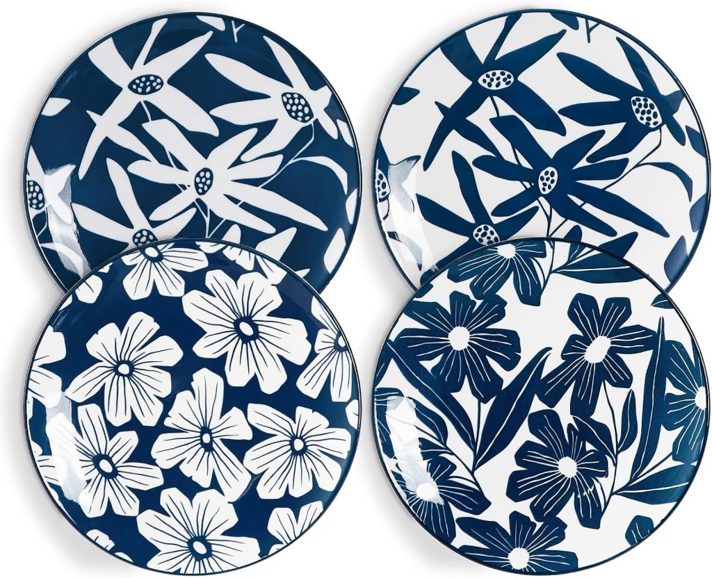 Four ceramic plates with bold blue and white floral patterns, each featuring a different flower design that looks hand-crafted, reminiscent of decorative air dry clay art.