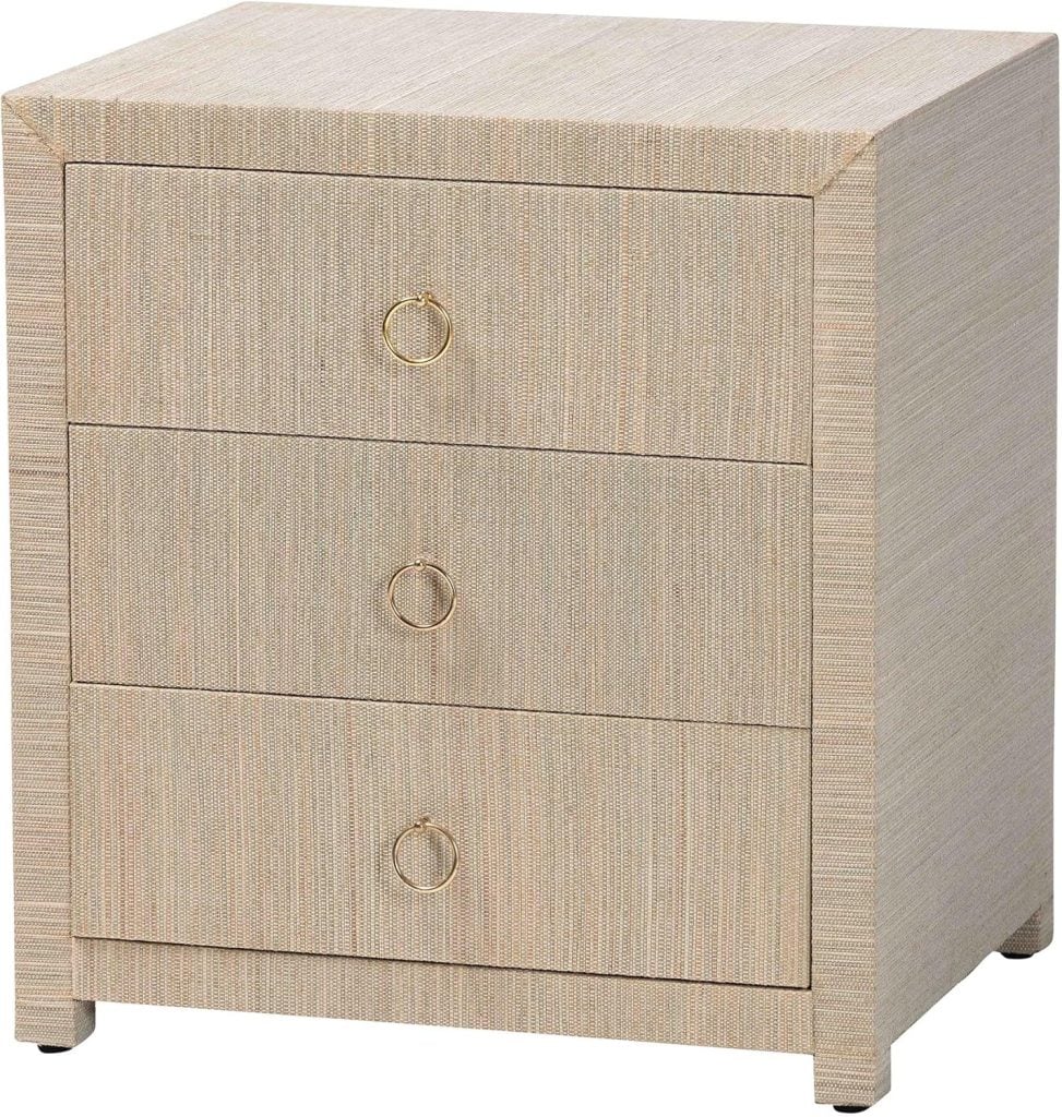 A square, light-colored three-drawer nightstand with gold ring handles on each drawer—an elegant choice often recommended by interior designers.