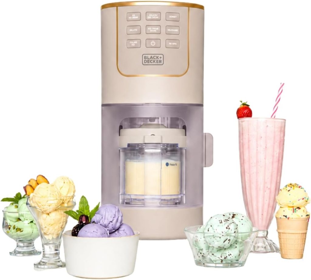 A Black+Decker ice cream maker, reminiscent of the popular Ninja Creami, is surrounded by bowls of various ice cream flavors and a strawberry milkshake with a straw and garnish.