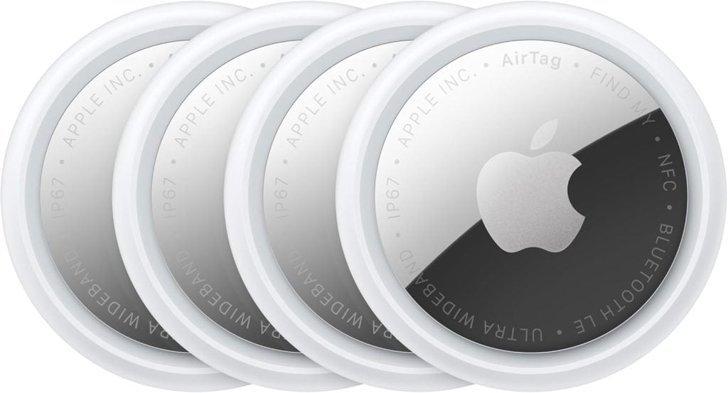 Four Apple AirTag tracking devices are arranged in a slightly overlapping row, displaying their silver and white circular design with the Apple logo&mdash;a smart choice for Amazon Prime shoppers seeking reliable tracking.