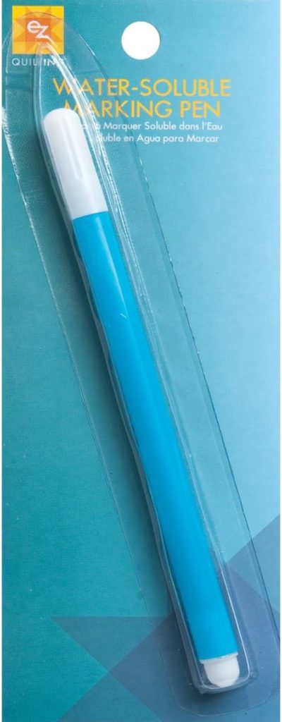 A packaged blue EZ Quilting water-soluble marking pen with a white cap on a blue card background, perfect for Creative Crafts projects.