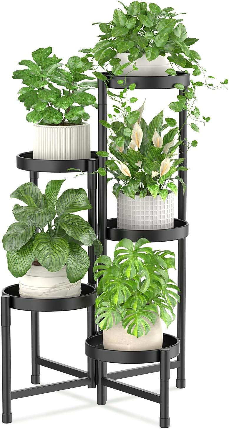 Black metal corner plant stand, available with Amazon Prime, holds five potted green plants of various leaf shapes and sizes on multiple tiered shelves.