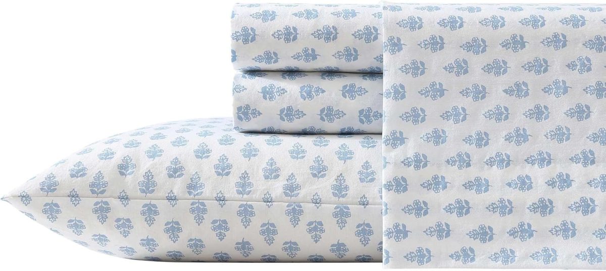 A stack of folded bed sheets and a pillowcase featuring a light blue floral pattern on a white background&mdash;perfect for refreshing your bedroom d&eacute;cor this Amazon Prime Day.