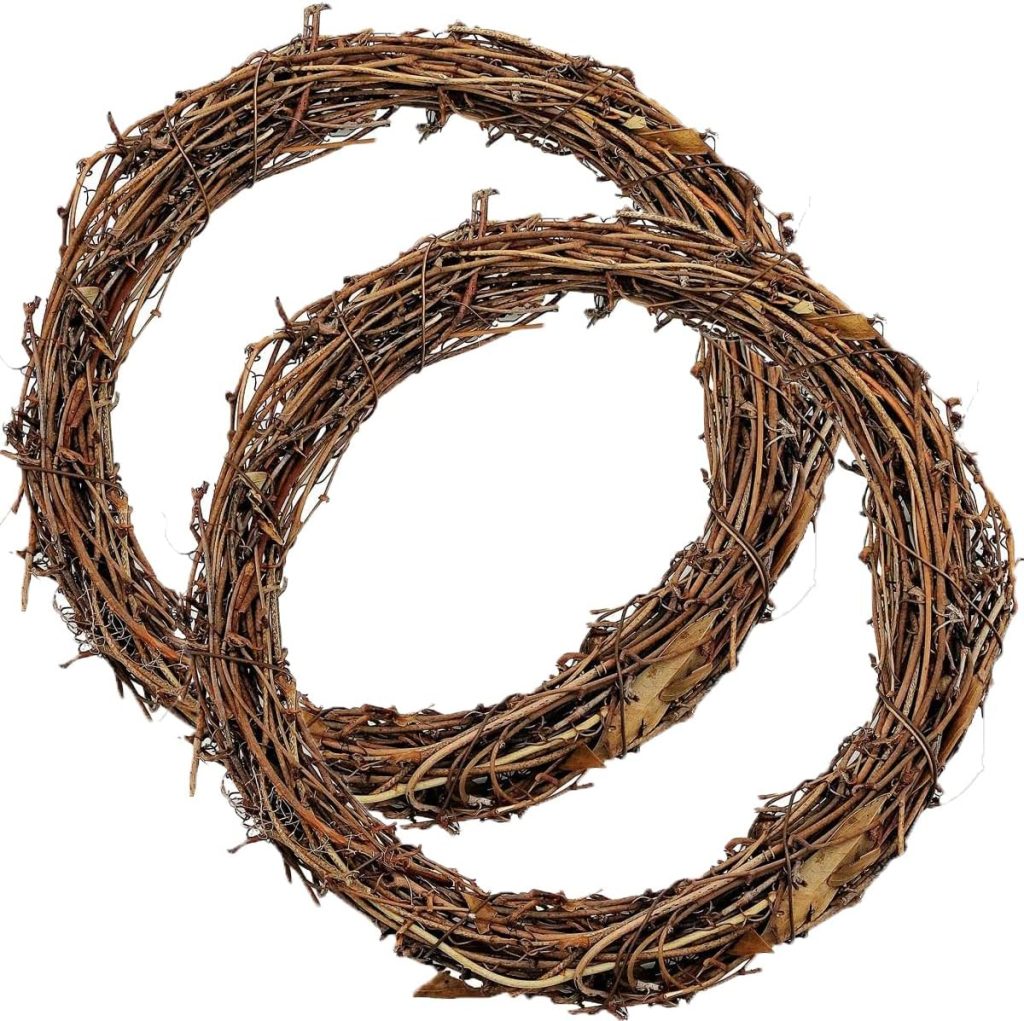 Two intertwined wreaths made of brown twigs and dried leaves, arranged on a white background, perfect for Creative Crafts and DIY projects.