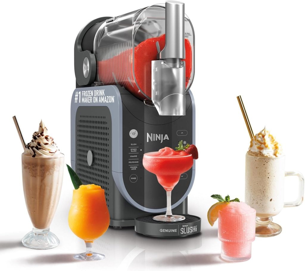 A Ninja frozen drink maker with a slushy inside, surrounded by glasses of blended drinks—milkshake, margarita, and smoothie—perfect for Amazon Prime Day celebrations.