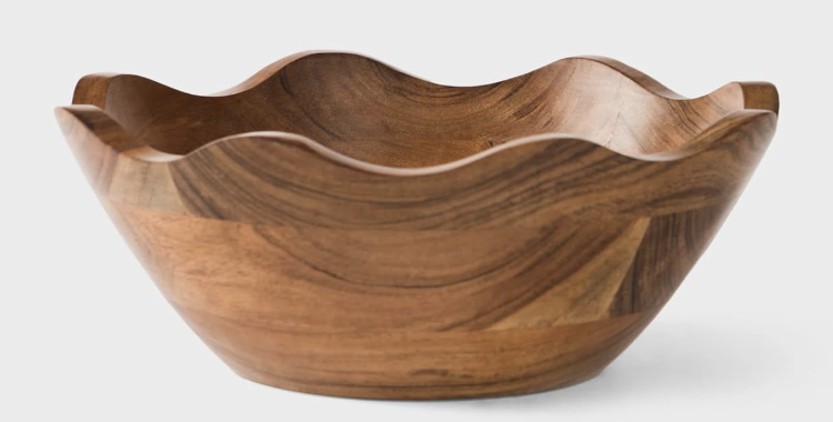 A large, round wooden bowl with a wavy, scalloped rim, featuring natural wood grain patterns—perfect for serving fresh salads or sides at your outdoor grilling station—set against a plain white background.