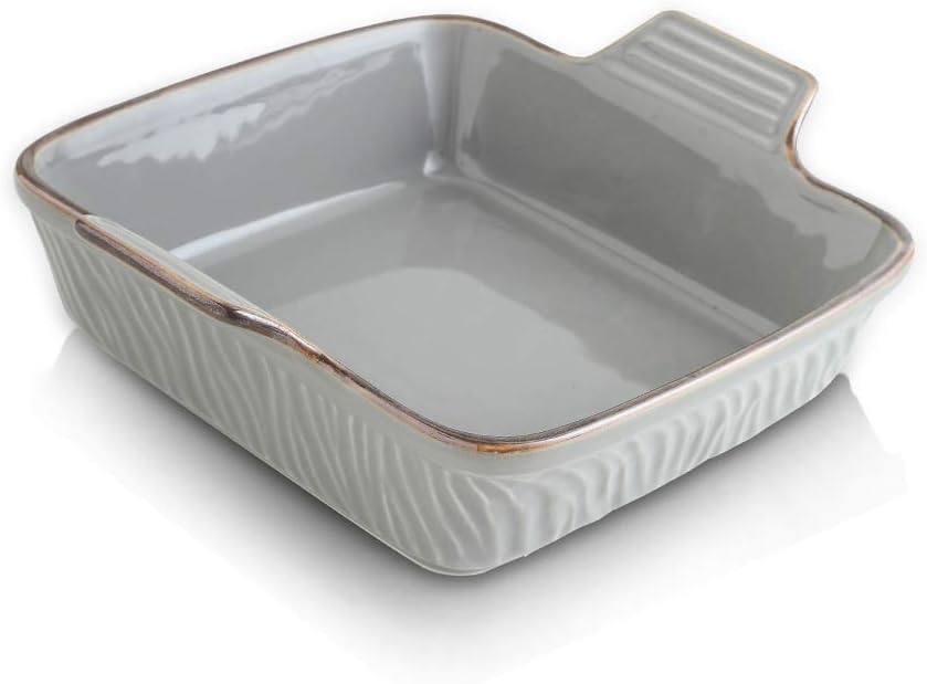 A square, gray ceramic baking dish with textured sides and an extended handle on one corner, perfect for baking creamsicle recipes, shown on a white background.