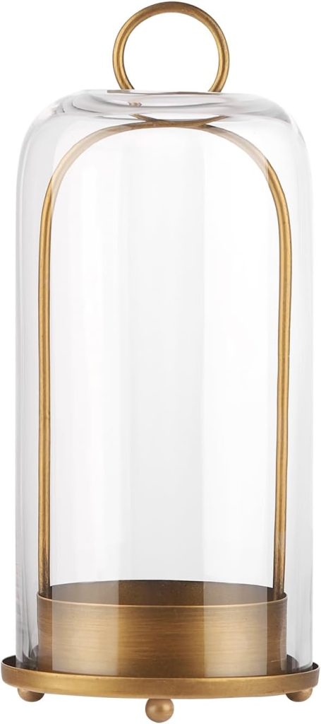 A glass cloche with a brass base and handle, featuring a dome-shaped cover and three small feet.
