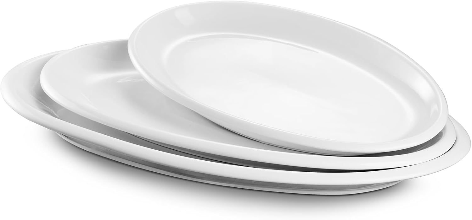 Four white oval ceramic plates stacked together on a white background.