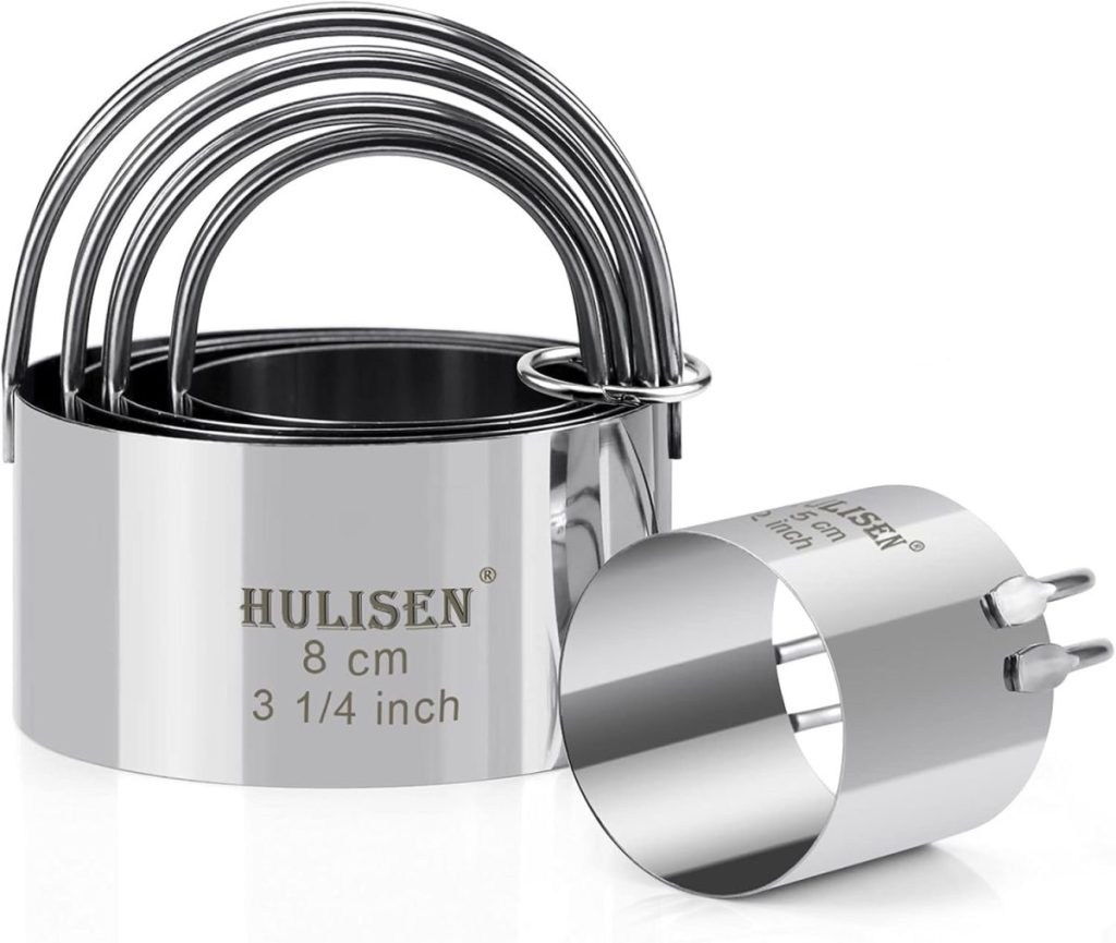 A set of round stainless steel biscuit cutters with handles, one shown separately. The cutter is marked "Hulisen, 8 cm, 3 1/4 inch.