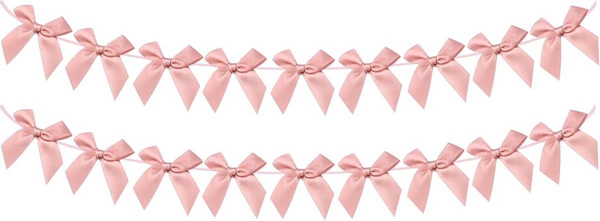 Two horizontal strings of evenly spaced, light pink ribbon bows are displayed on a white background.