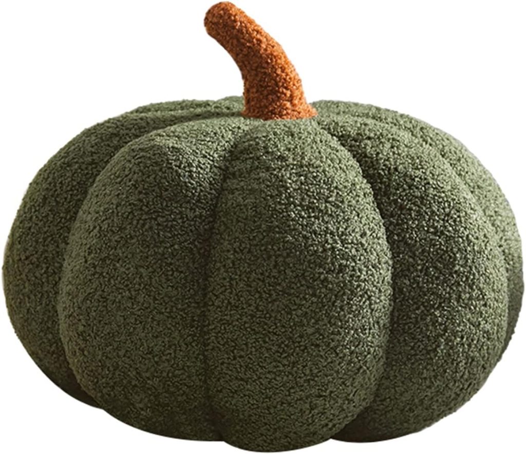 A plush, textured green pumpkin with a brown stem, resembling a soft decorative pillow.
