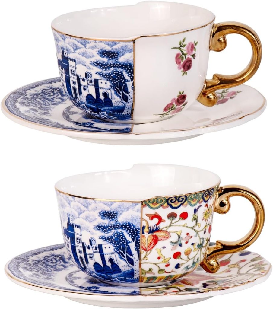 Two porcelain teacups and saucers with gold handles, each divided into contrasting patterns: one side classic blue-and-white, the other side floral designs in pink and multicolor.