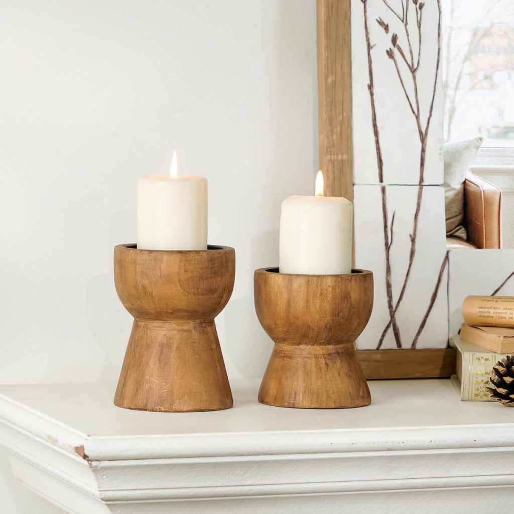 Two candles in a wooden holder.