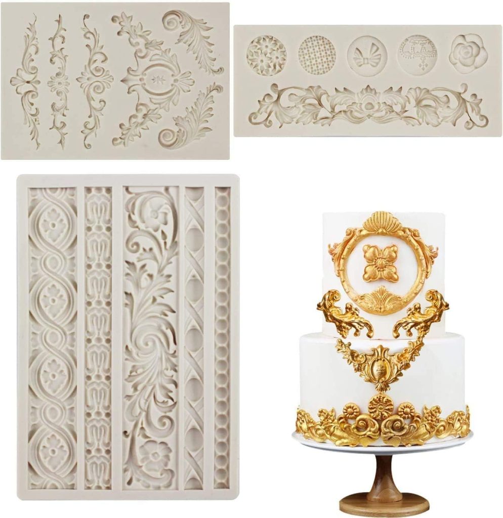 Three ornate silicone molds with intricate patterns are shown above a white cake decorated with gold fondant details made from the molds, displayed alongside a stylish ceramic planter.