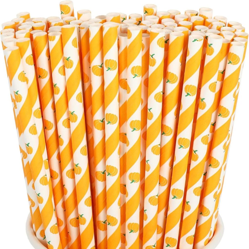A group of orange and white striped paper straws with small pumpkin illustrations, standing upright in a container—perfect for serving festive drinks or your favorite creamsicle recipes.