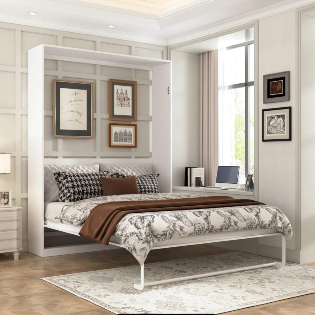 A modern bedroom with a pull-down Murphy bed, patterned bedding, a rug, framed art on the wall, a window with desk and chair, and parquet flooring.