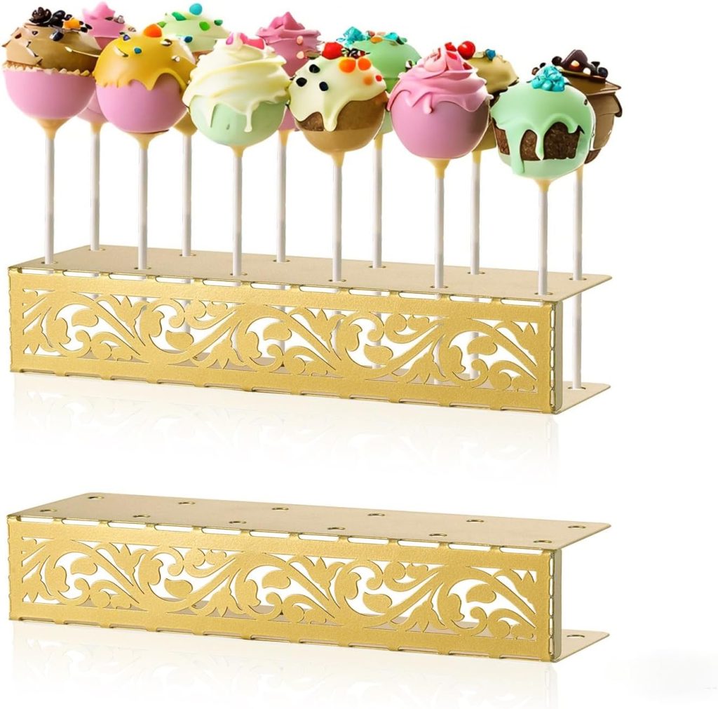 A decorative gold cake pop stand holding colorful decorated cake pops, with an empty matching stand placed in front.