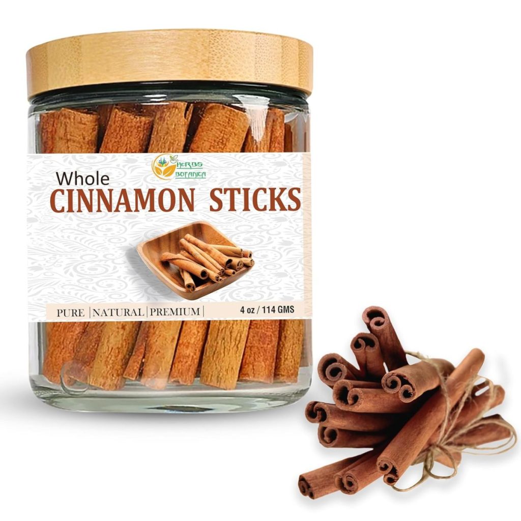 A glass jar labeled "Whole Cinnamon Sticks" with a bamboo lid, filled with cinnamon sticks, sits next to a bundle of loose sticks—perfect for adding warm flavor to your favorite creamsicle recipes.
