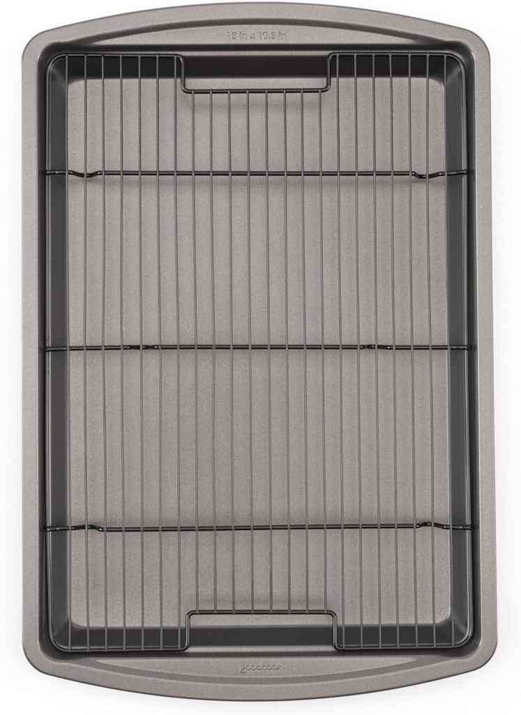 A rectangular metal baking sheet with a removable wire cooling rack placed inside.