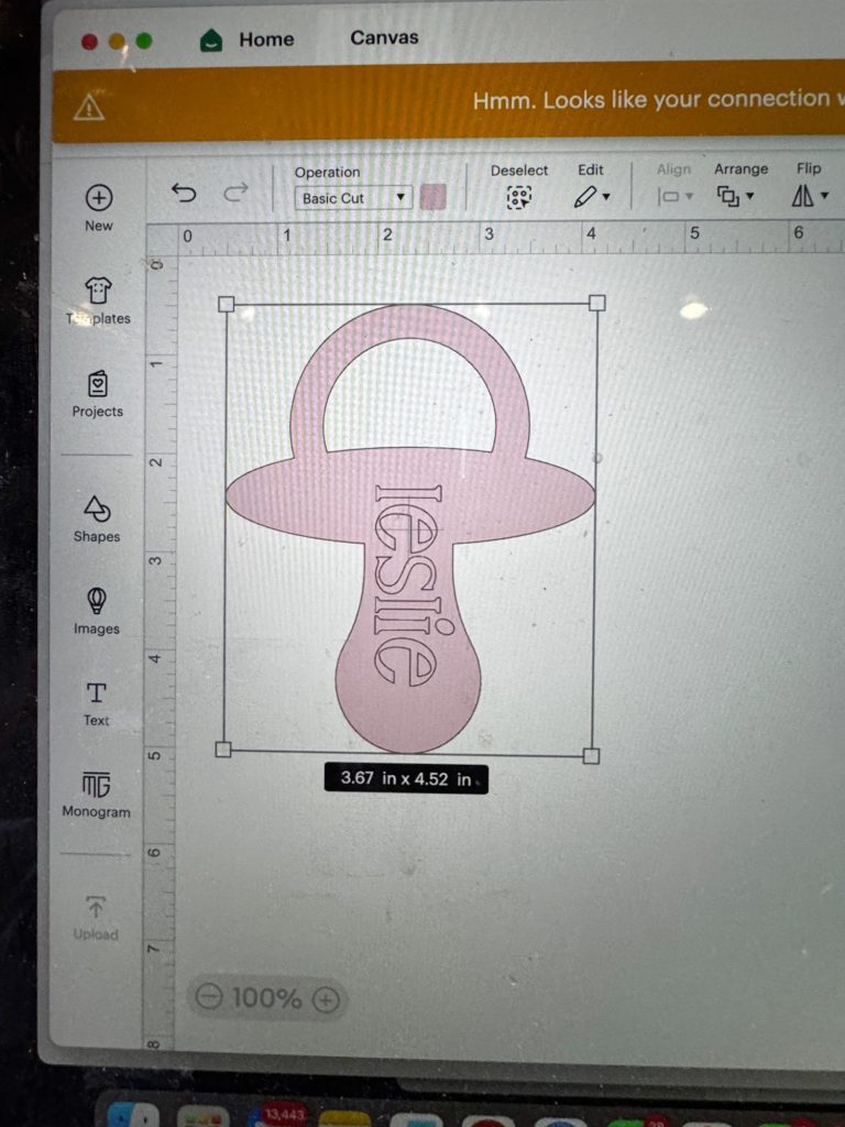 A computer screen displays a pink pacifier design with the name "leslie" vertically in the center, shown in design software with size dimensions of 3.67 in x 4.52 in.