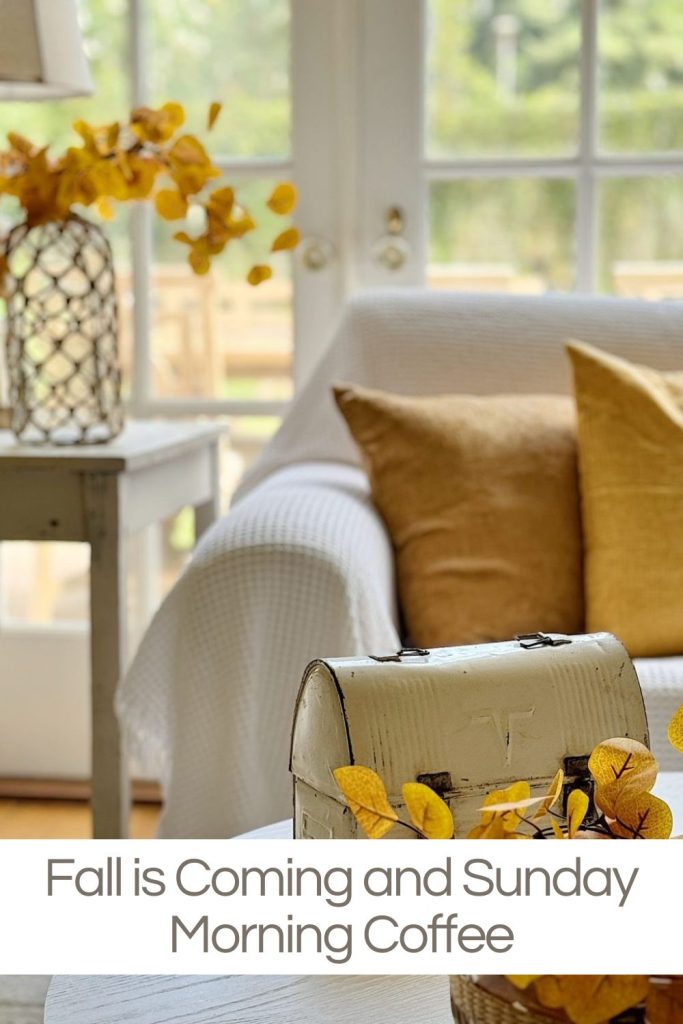 A cozy living room with yellow autumn leaves in a vase, neutral-toned decor, and a white armchair, with text reading "Fall is Coming and Sunday Morning Coffee.