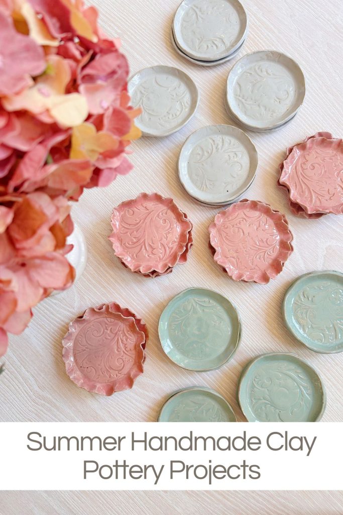 Assorted round handmade clay dishes in pink and green tones with embossed patterns, displayed on a light surface next to pink hydrangea flowers. Text reads: "Summer Handmade Clay Pottery Projects.