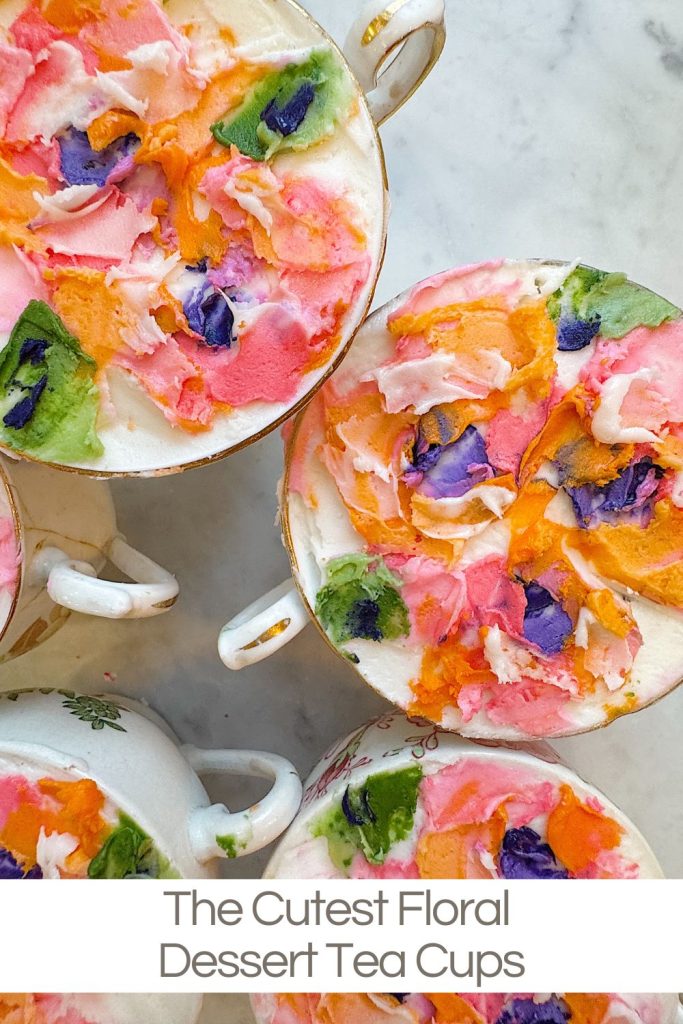 Overhead view of teacups filled with dessert, decorated with colorful, flower-like patterns in pink, orange, purple, green, and white.