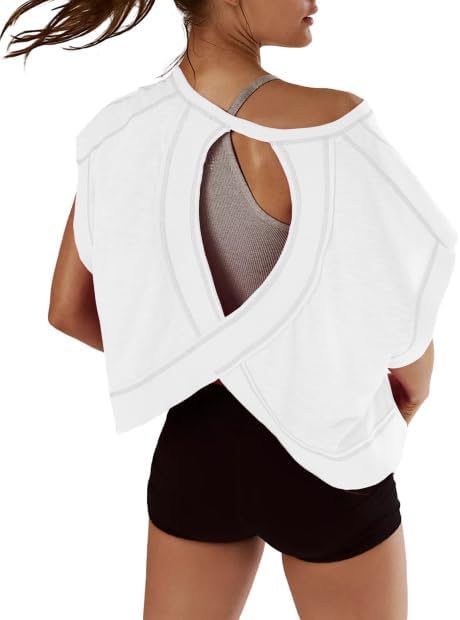A woman is wearing a white open-back top over a gray sports bra and black shorts, shown from behind—perfect for your next workout and available during Amazon Prime Big Deal Days.