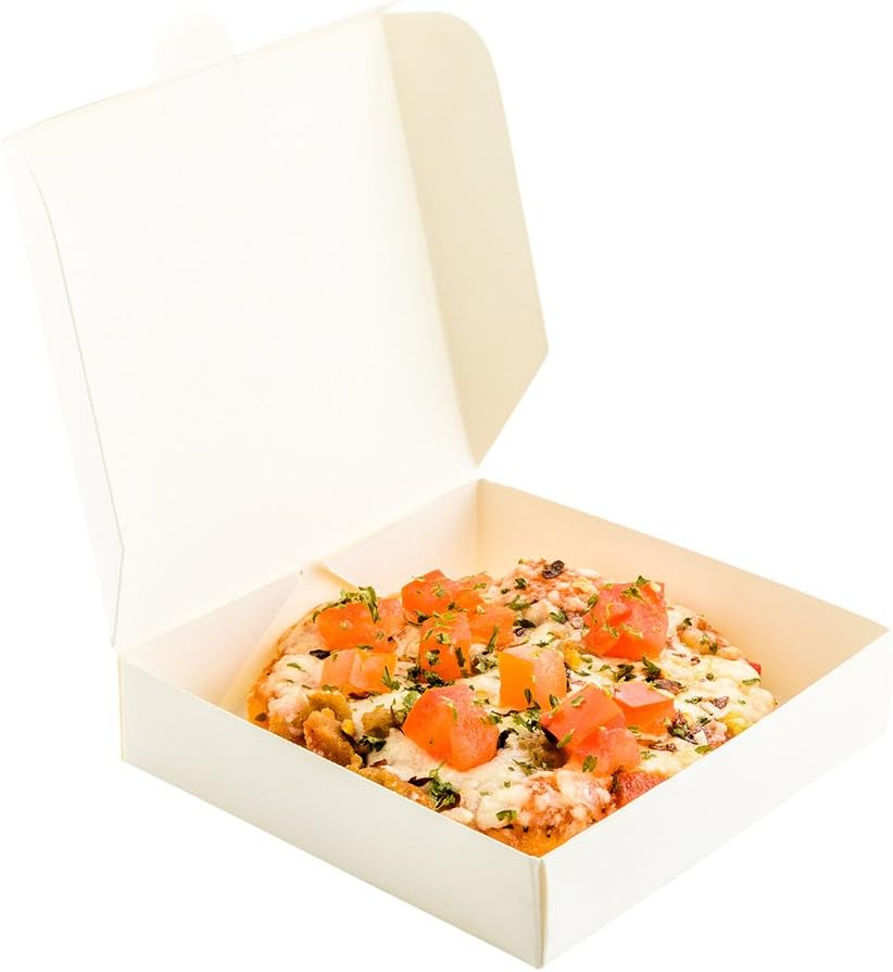 A small pizza topped with diced tomatoes and herbs sits inside an open white pizza box, photographed against a white background—a perfect bite for gatherings inspired by A Home to Share.
