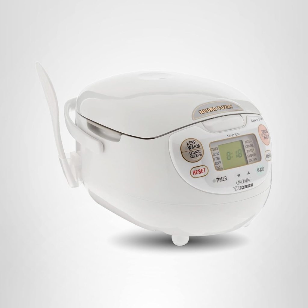 A white Zojirushi Neuro Fuzzy rice cooker with digital display, buttons, and a rice paddle holder is shown on a light gray background—perfect for upgrading your kitchen during Amazon Prime Big Deal Days.