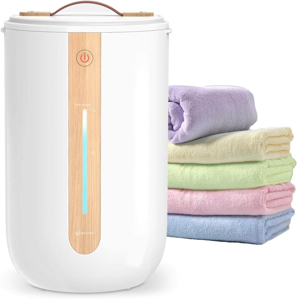 A white and wood-colored towel warmer sits beside a neatly folded stack of four pastel-colored towels, perfect for upgrading your bathroom during Amazon Prime Big Deal Days.