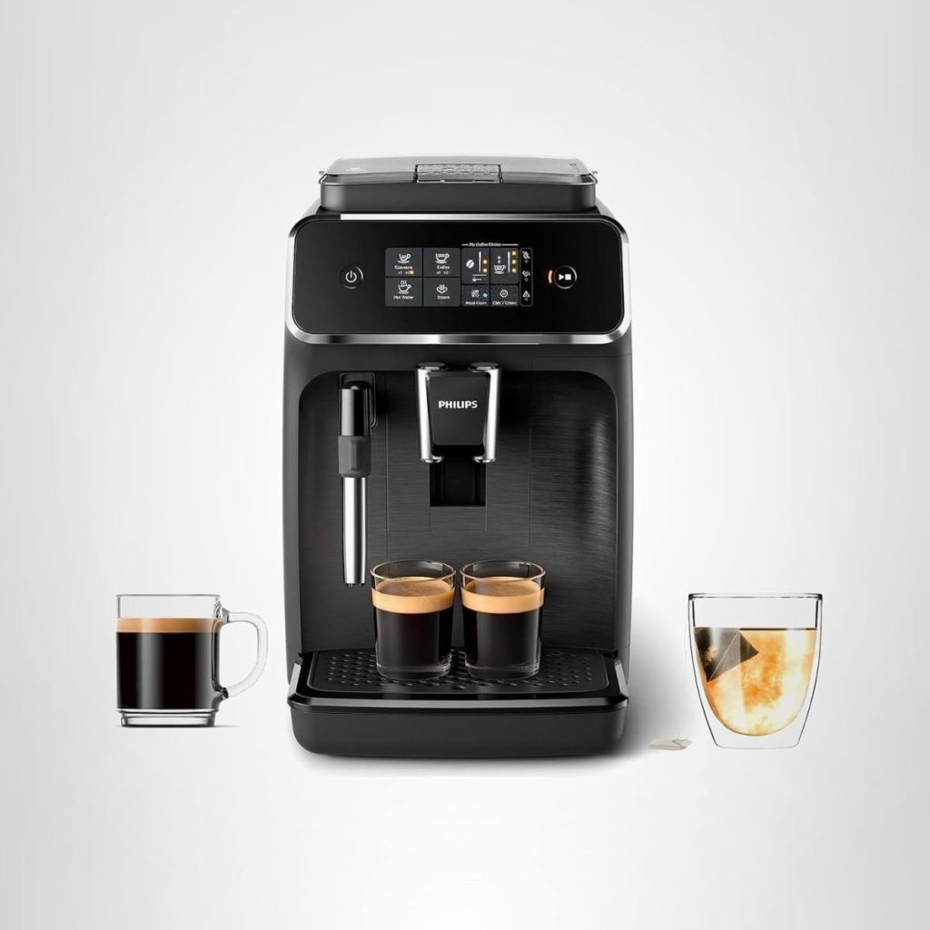 A black Philips coffee machine with two espresso cups, a mug of black coffee on the left, and a glass of iced coffee on the right, set against a plain white background—perfect for Amazon Prime Big Deal Days savings.
