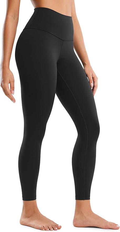 A person wearing high-waisted, full-length black leggings stands barefoot against a plain background—perfect for adding to your cart during Amazon Prime Big Deal Days.