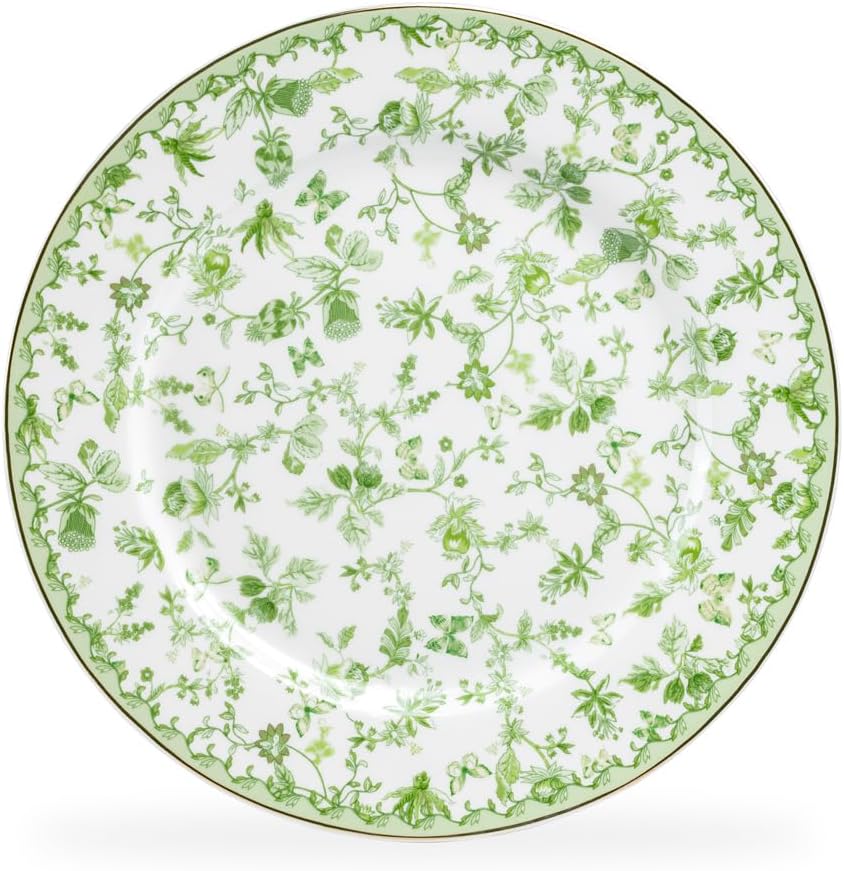 A round white ceramic plate featuring a detailed green floral and botanical pattern around the surface.