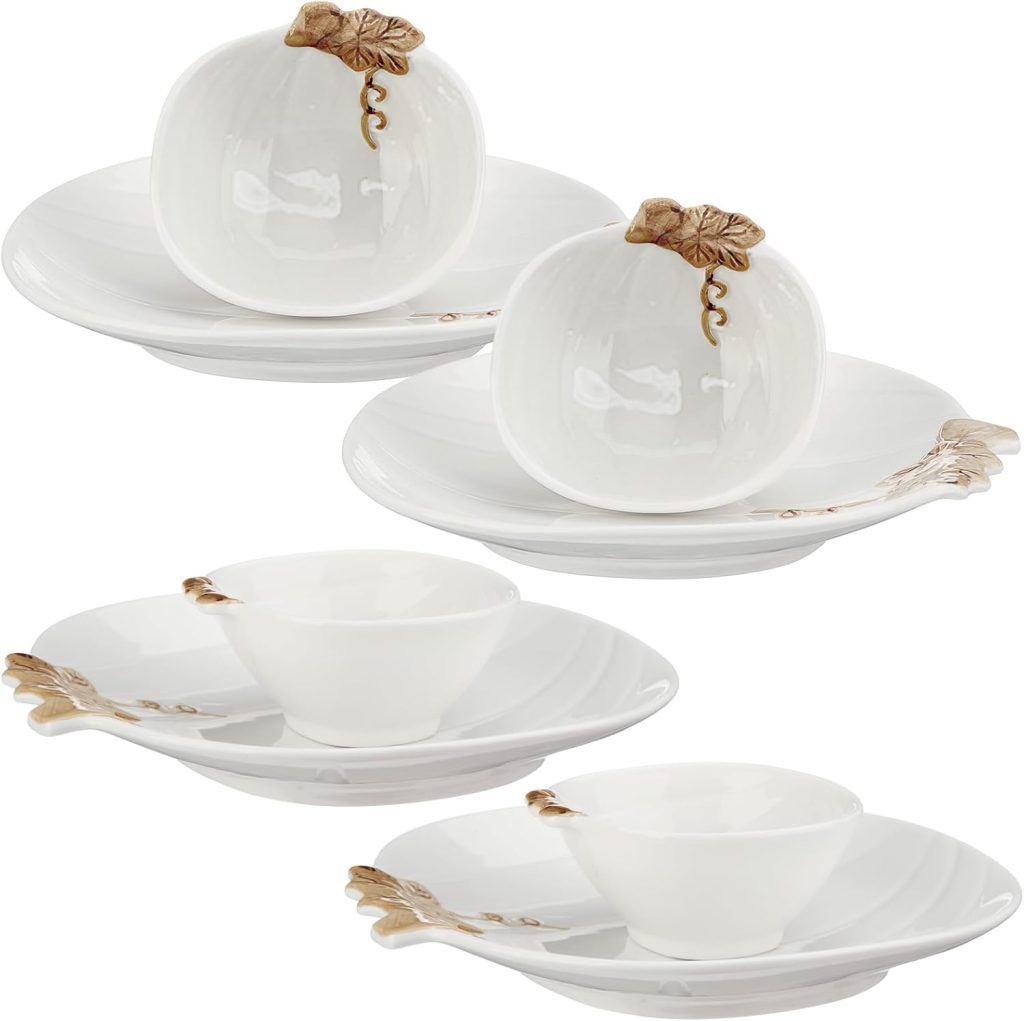 Four white plate and bowl sets, each with a pumpkin or leaf design detail in beige and gold tones, arranged on a white background.