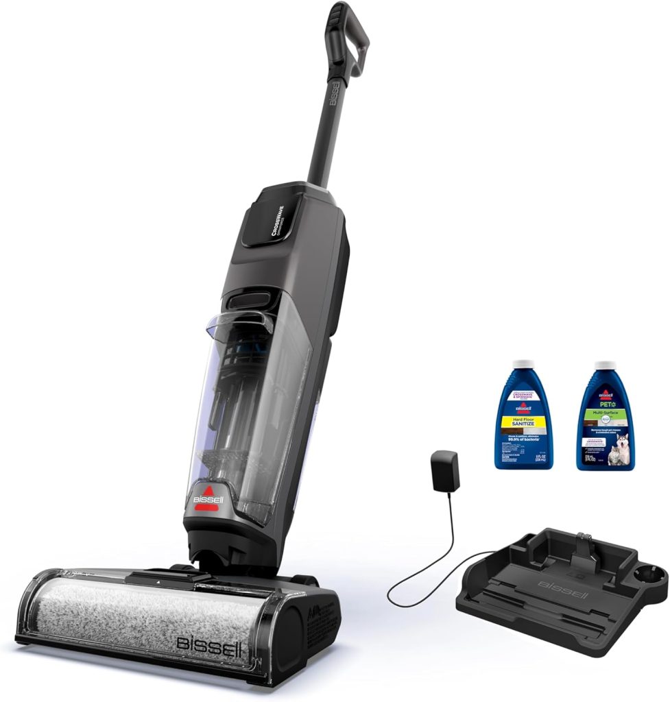 A Bissell vacuum cleaner with a charging dock, power adapter, and two cleaning solution bottles arranged beside it on a white background—perfect for grabbing during Amazon Prime Big Deal Days.