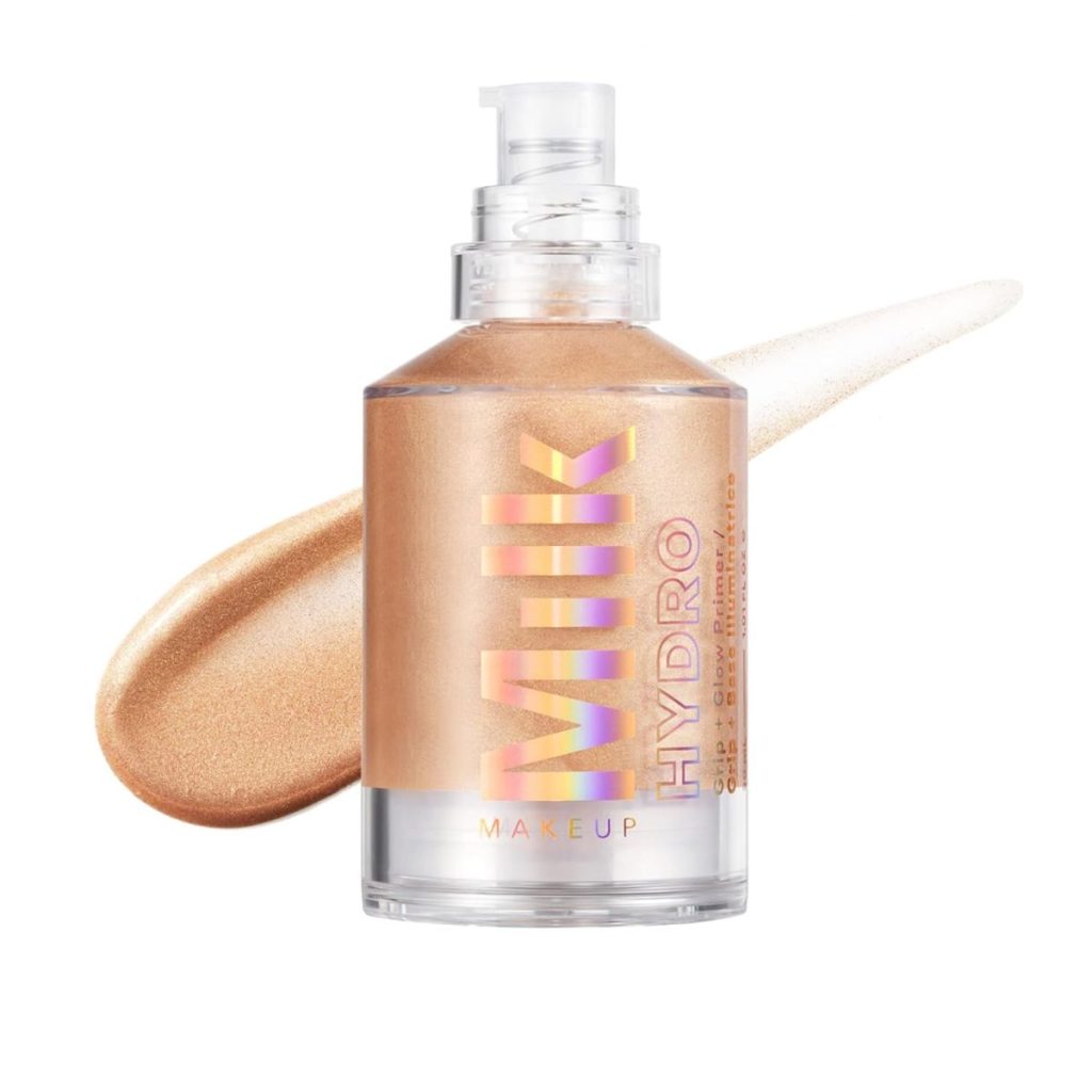 A clear pump bottle of Milk Makeup Hydro, filled with shimmery gold liquid, is shown with a swatch behind it on a white background—perfect for your next Amazon Prime Big Deal Days beauty haul.